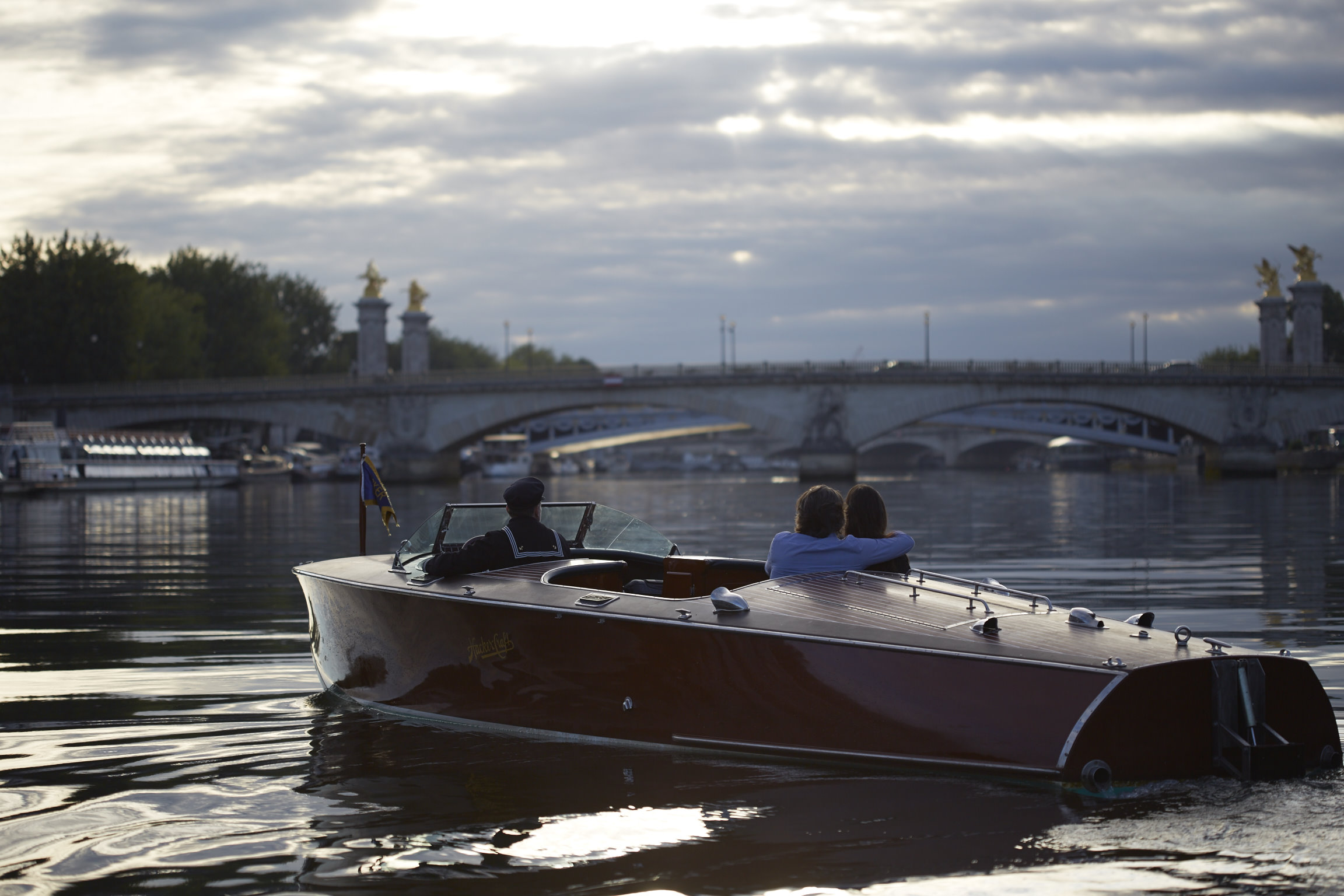 Couple on a boat with the Alexander III Bridge in the background